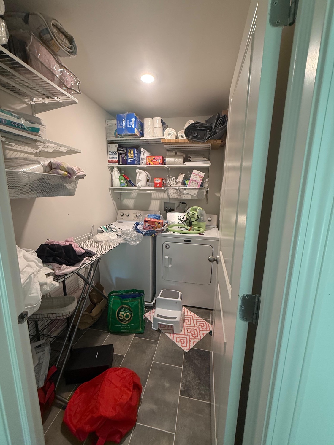 Cluttered laundry room before a deep cleaning
